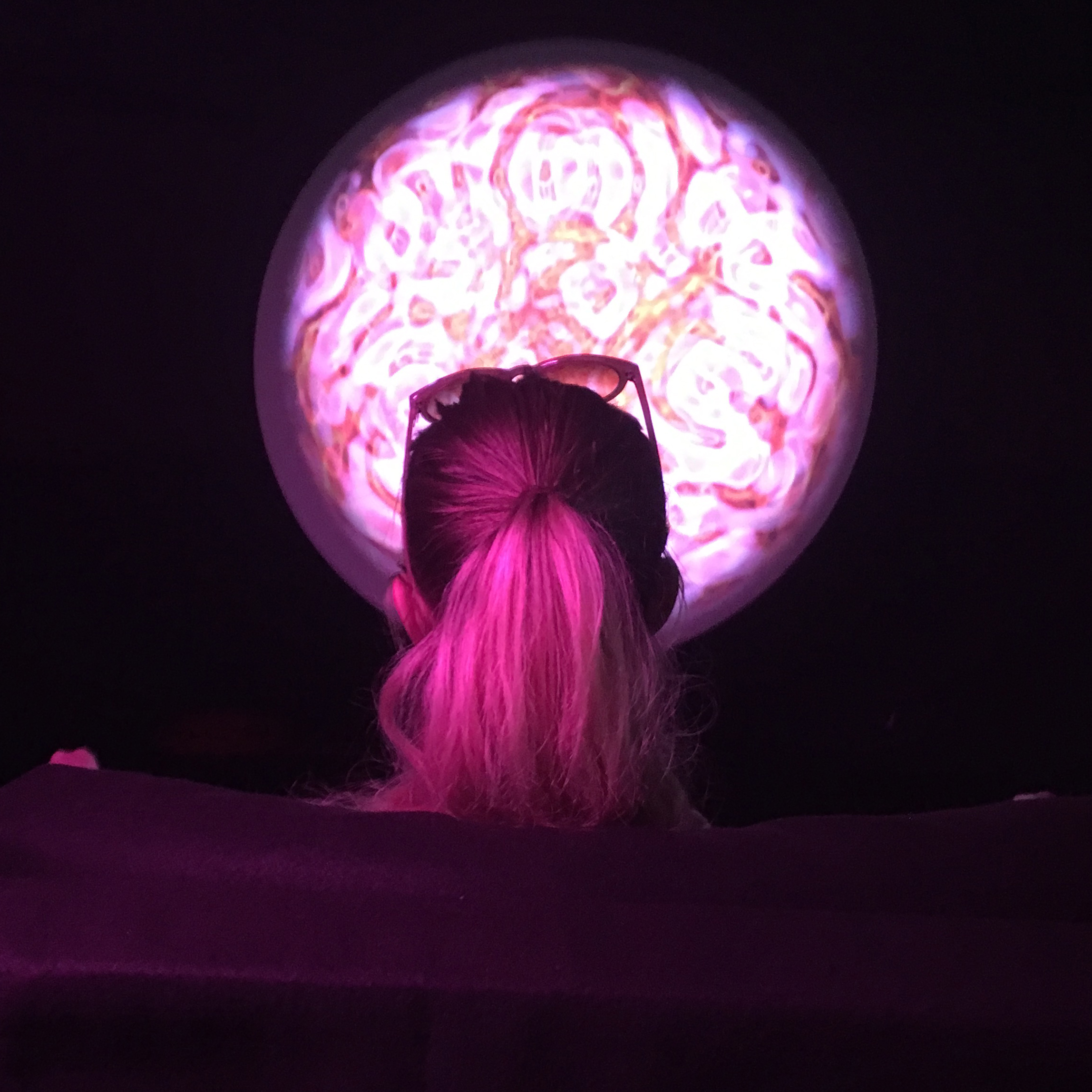 A view from behind a participant immersed in sound, vibrations and dancing geometries